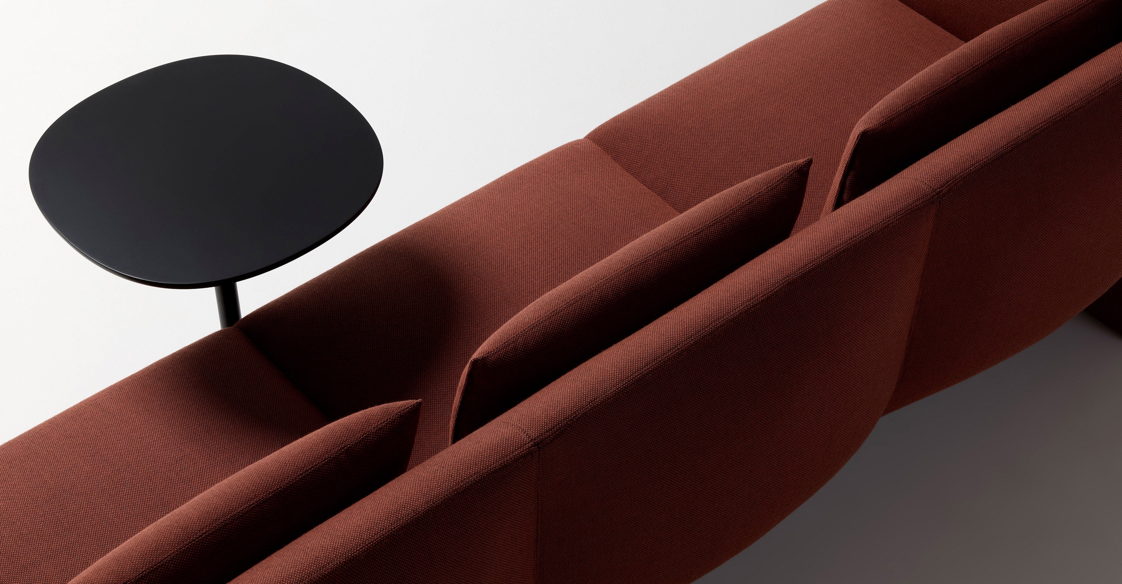 Ross Gardam Dwell lounge in red upholstery from back three quarter view